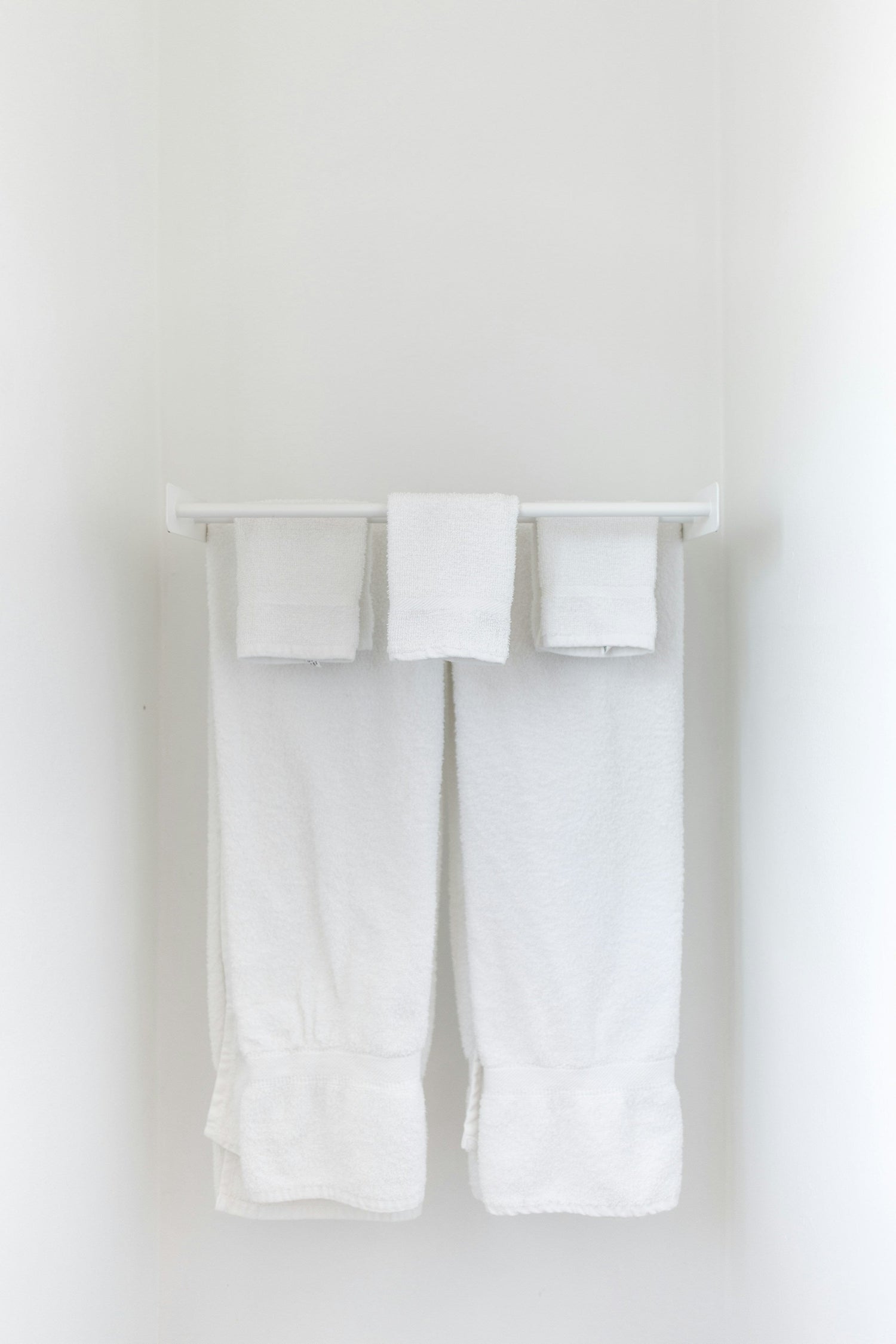Wall-mounted towel hooks and bars